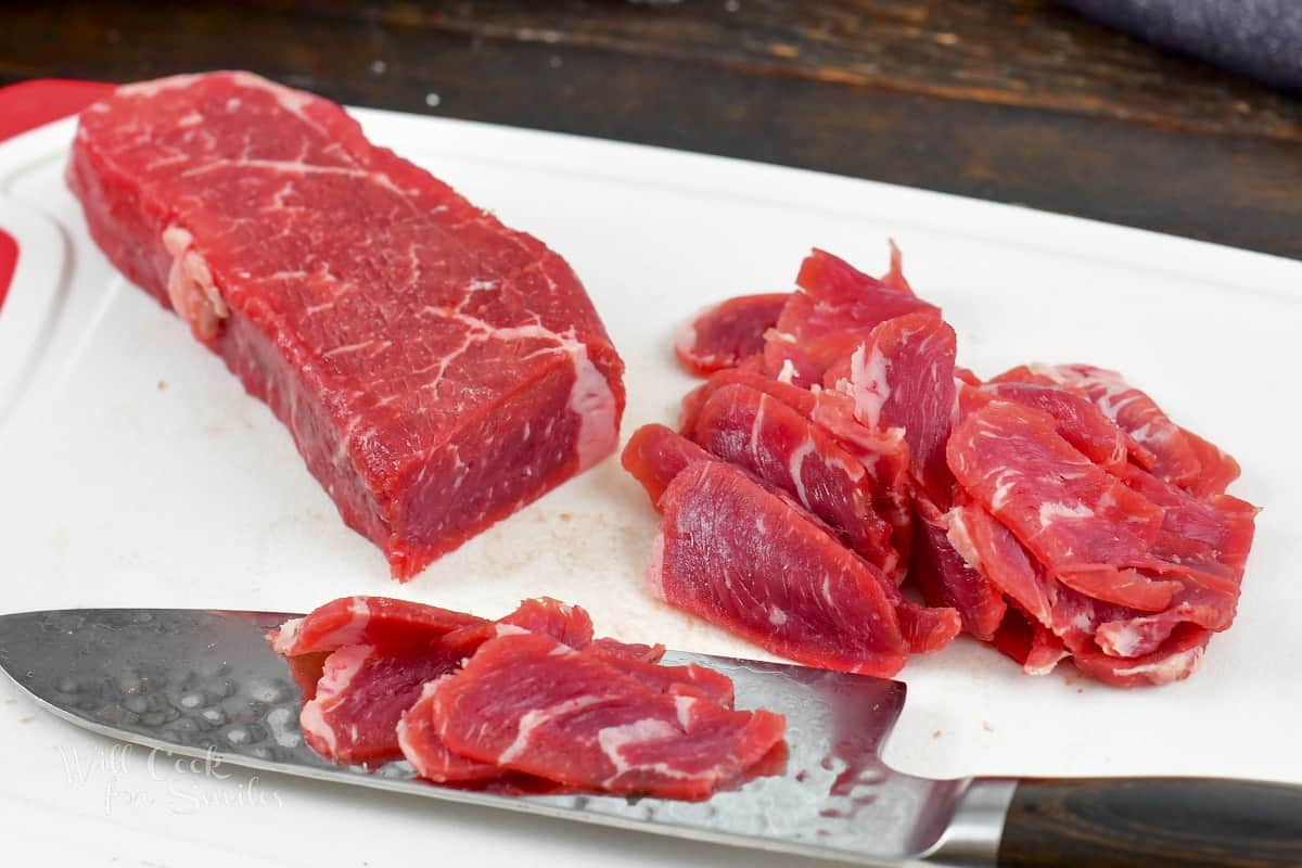 slicing a steak into thin slices