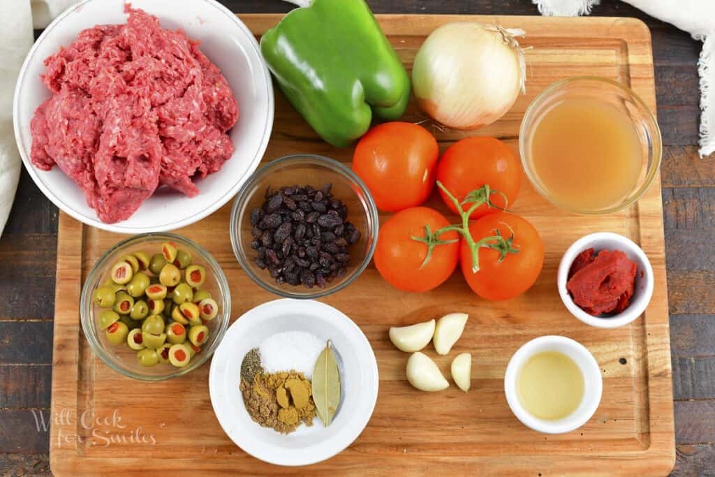 ingredients to make picadillo on the cutting board