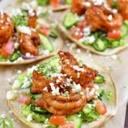 closeup of one shrimp tostada and more in background