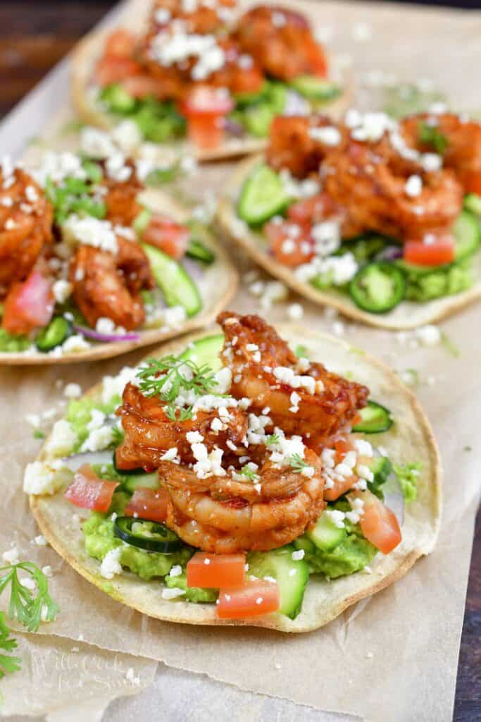 closeup of one shrimp tostada and more in background