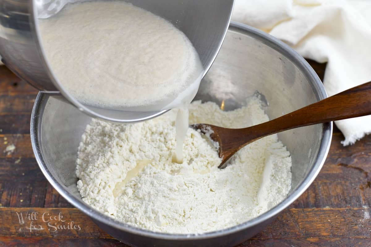 adding yeast liquid to the flour mixture.