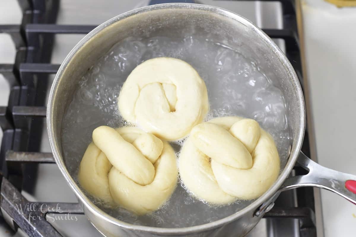 three pretzels boiling baking soda water.