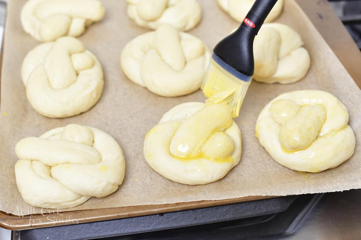 brushing unbaked pretzels with melted butter.