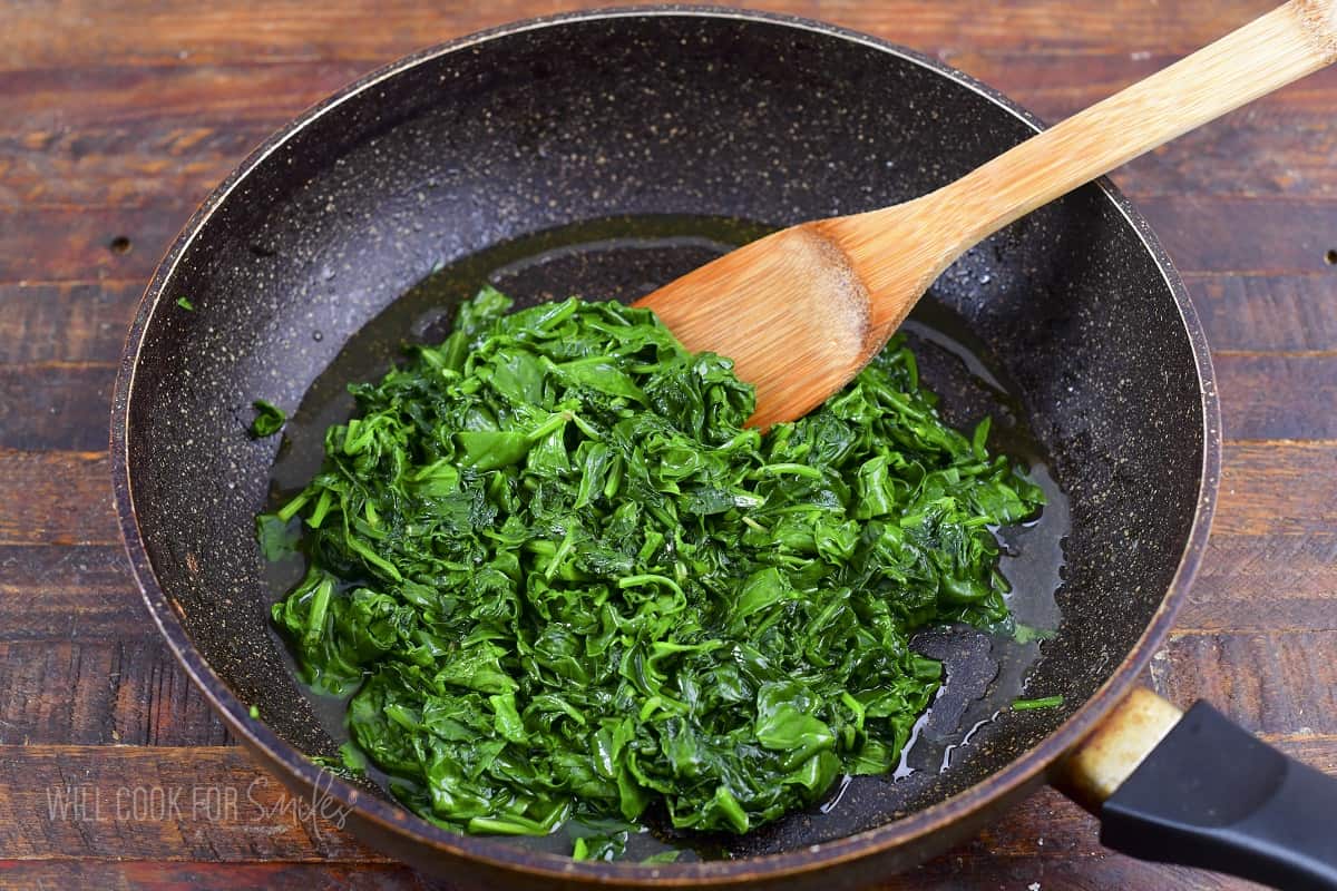cooked spinach in a pan.