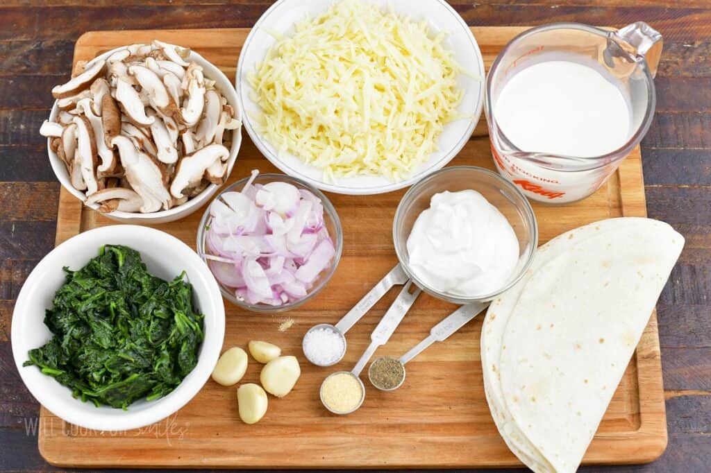 ingredients for vegetarian enchiladas on a board.