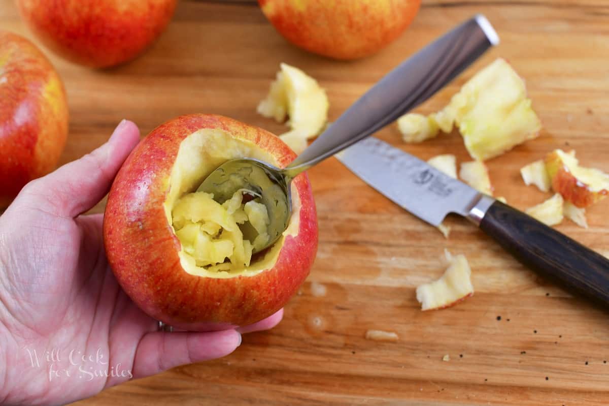 scooping out the apple with a spoon