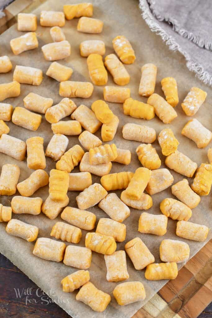 top view of sweet potato gnocchi spread out on parchment paper