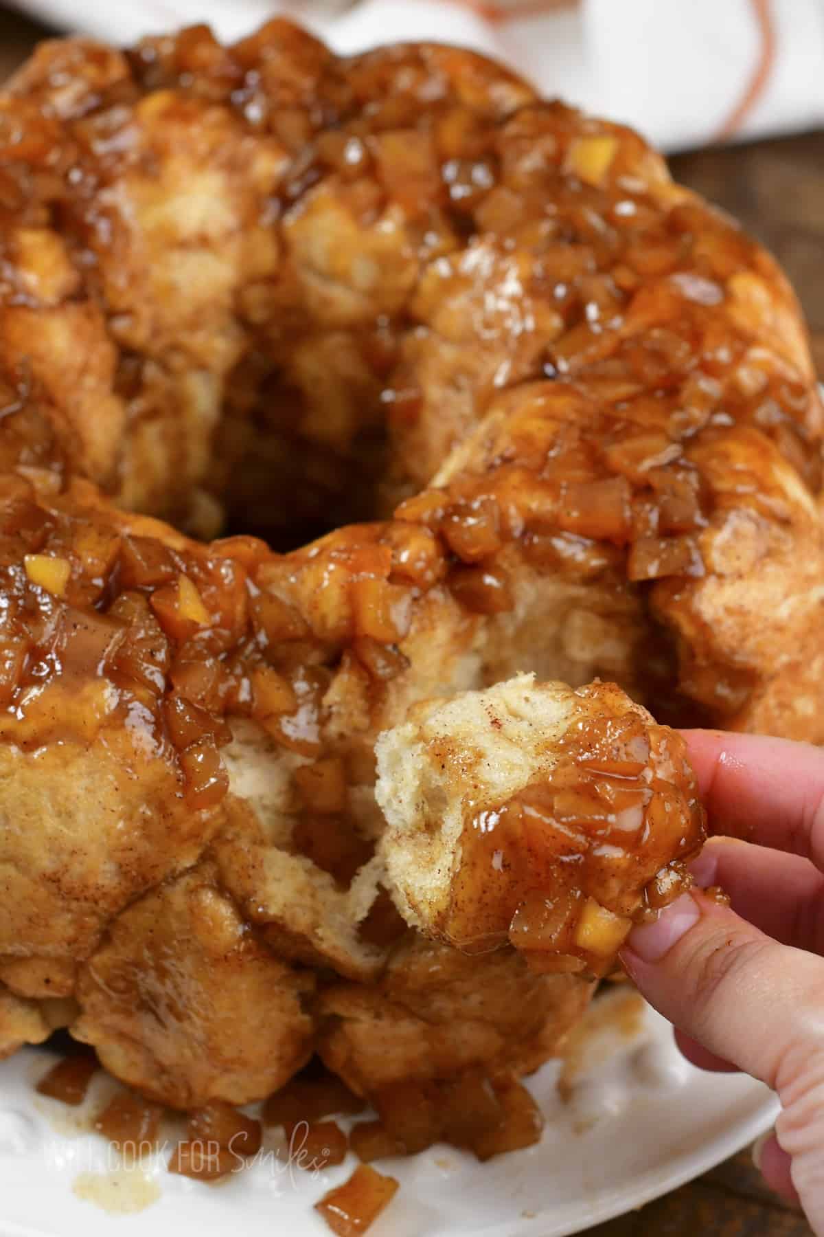 closeup of pulling off a piece of monkey bread.