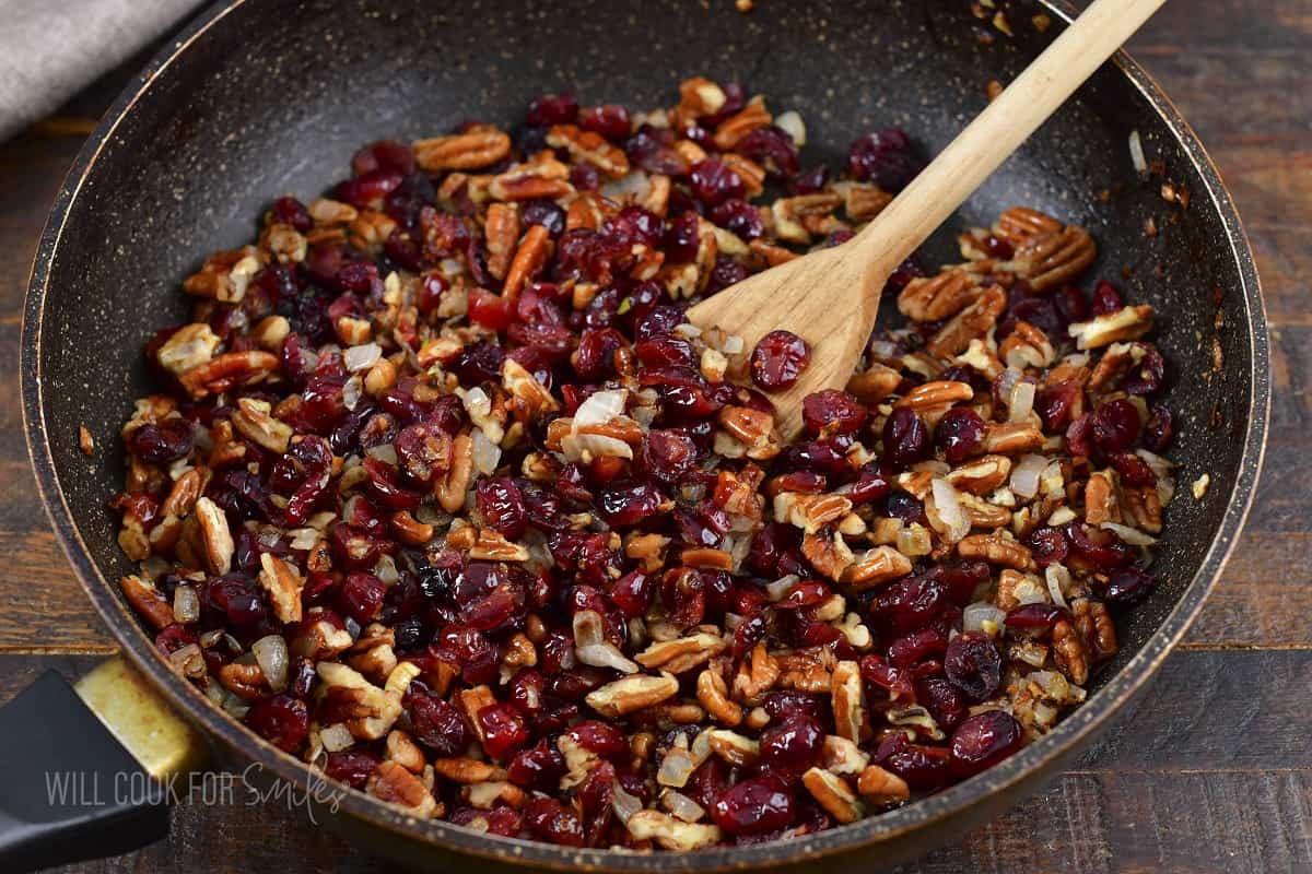 cranberry and pecan mixture sautéed in the pan.