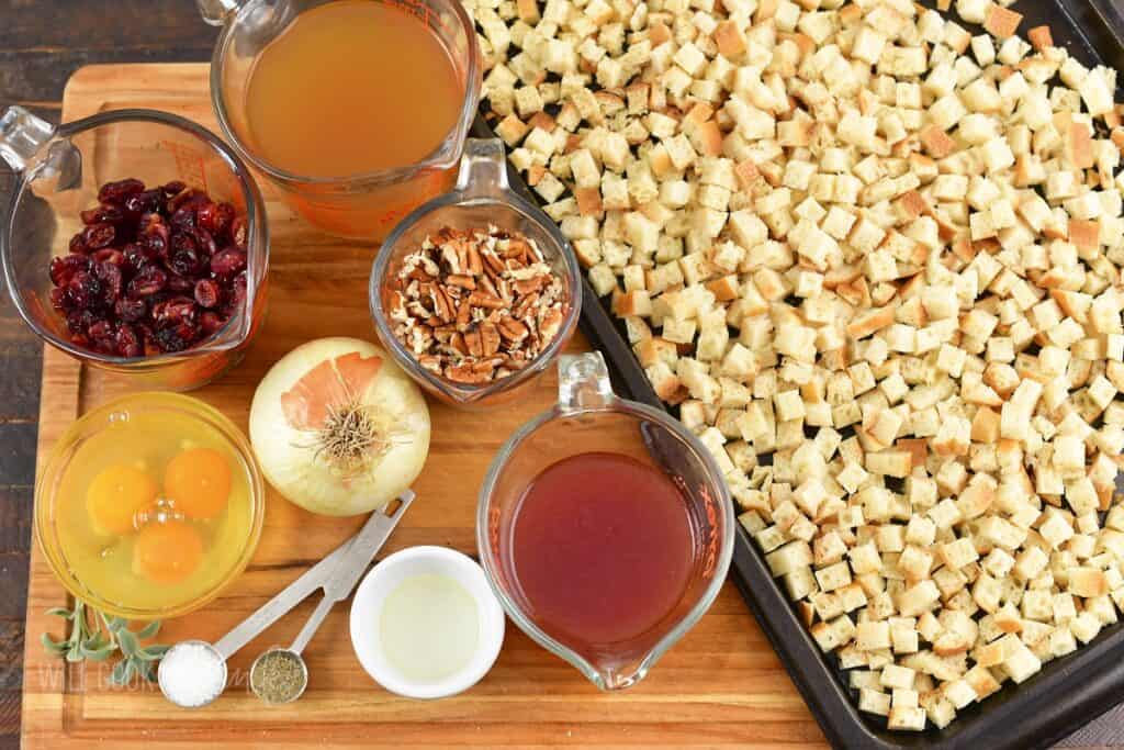 ingredients to make cranberry stuffing on the cutting board.