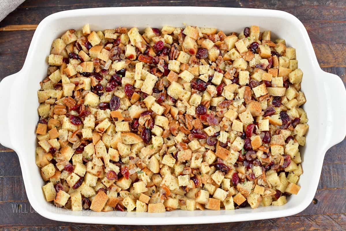 mixed cranberry stuffing spread in baking dish before baking.