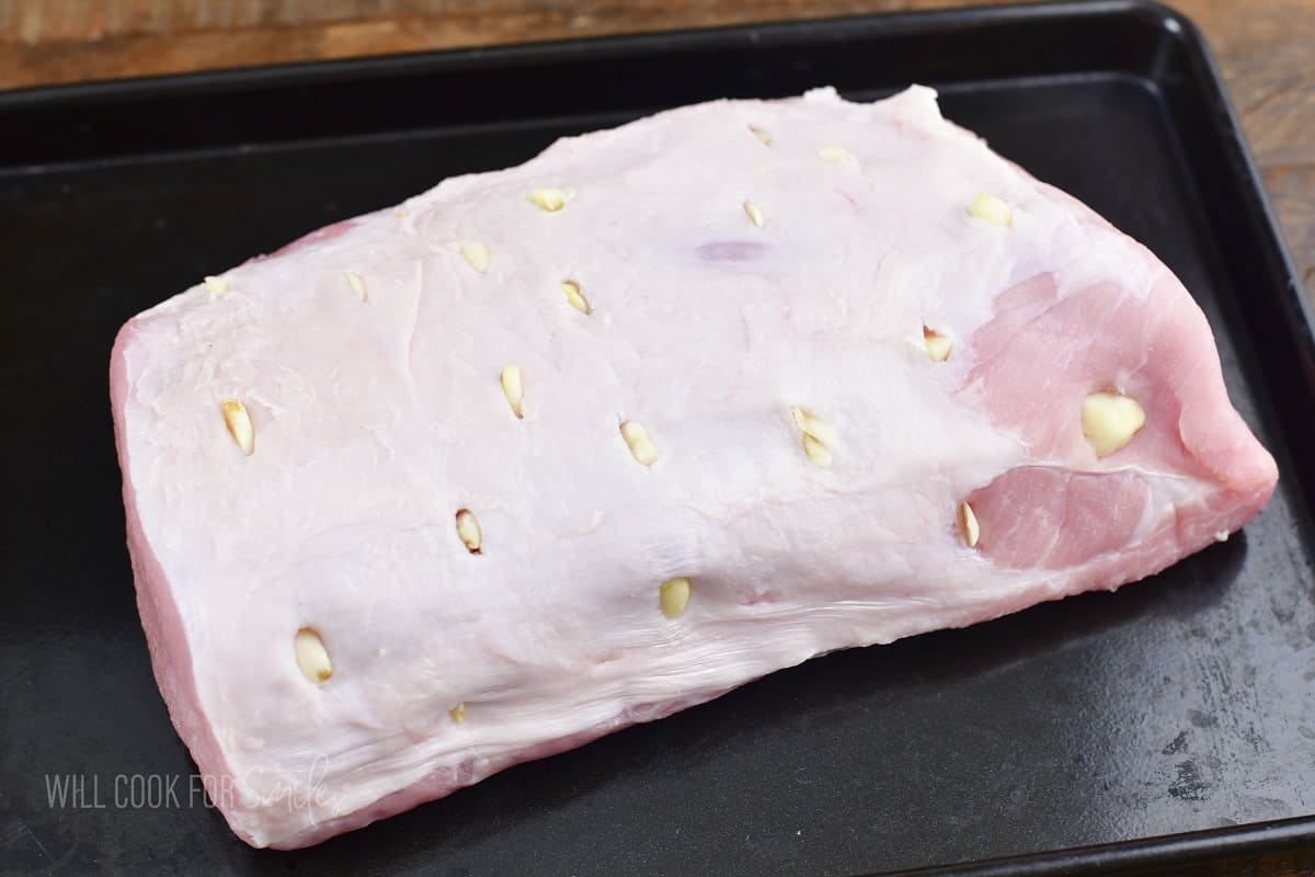 pork loin with garlic pieces inserted.