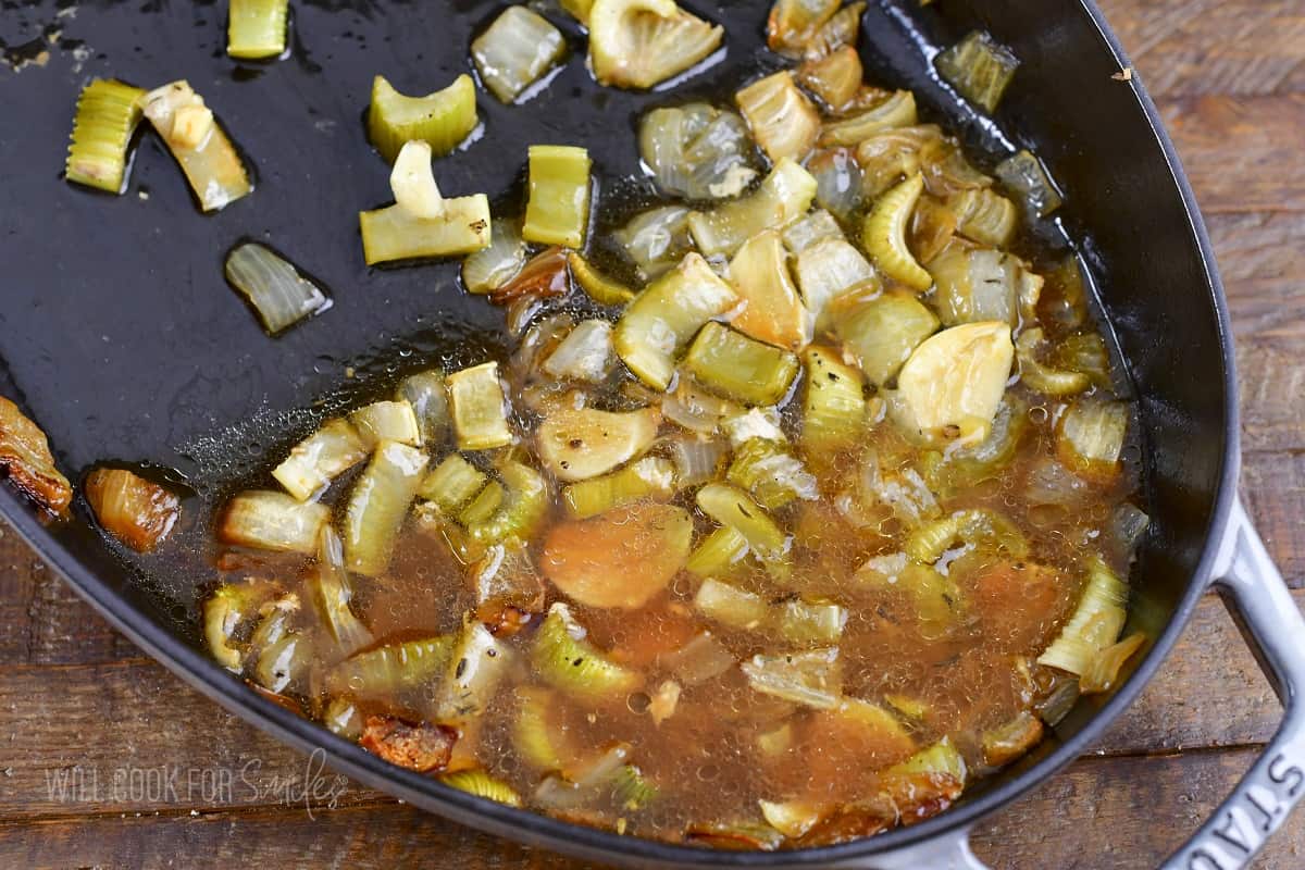 liquid and veggies in the roasting pan after baking.