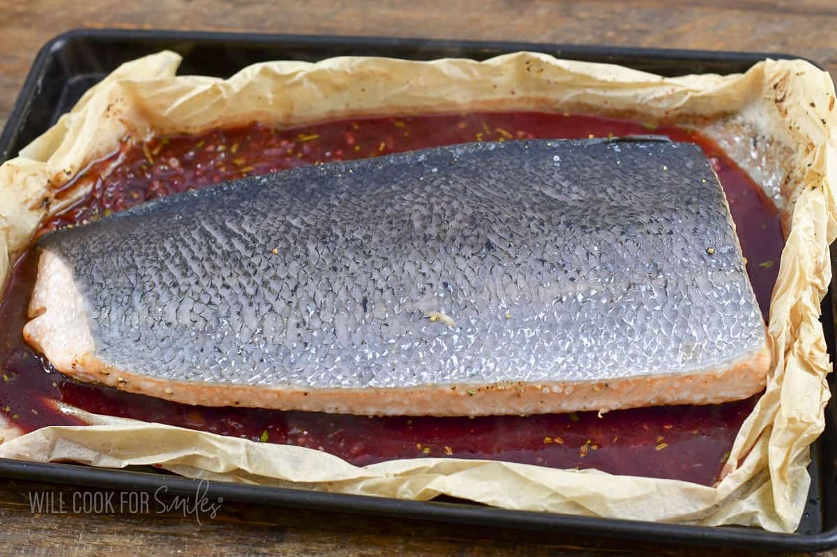 partially baked salmon skin side up in the baking dish.