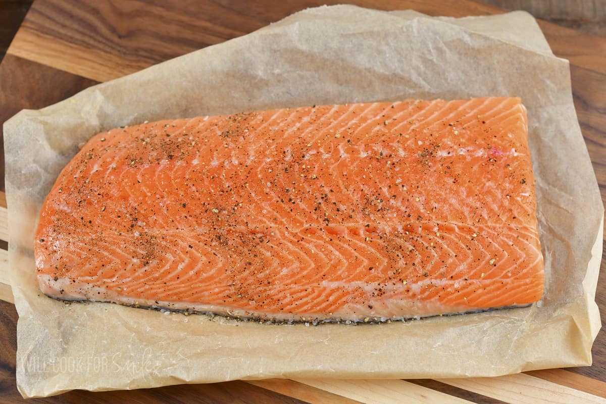 whole salmon filet seasoned with salt and pepper.