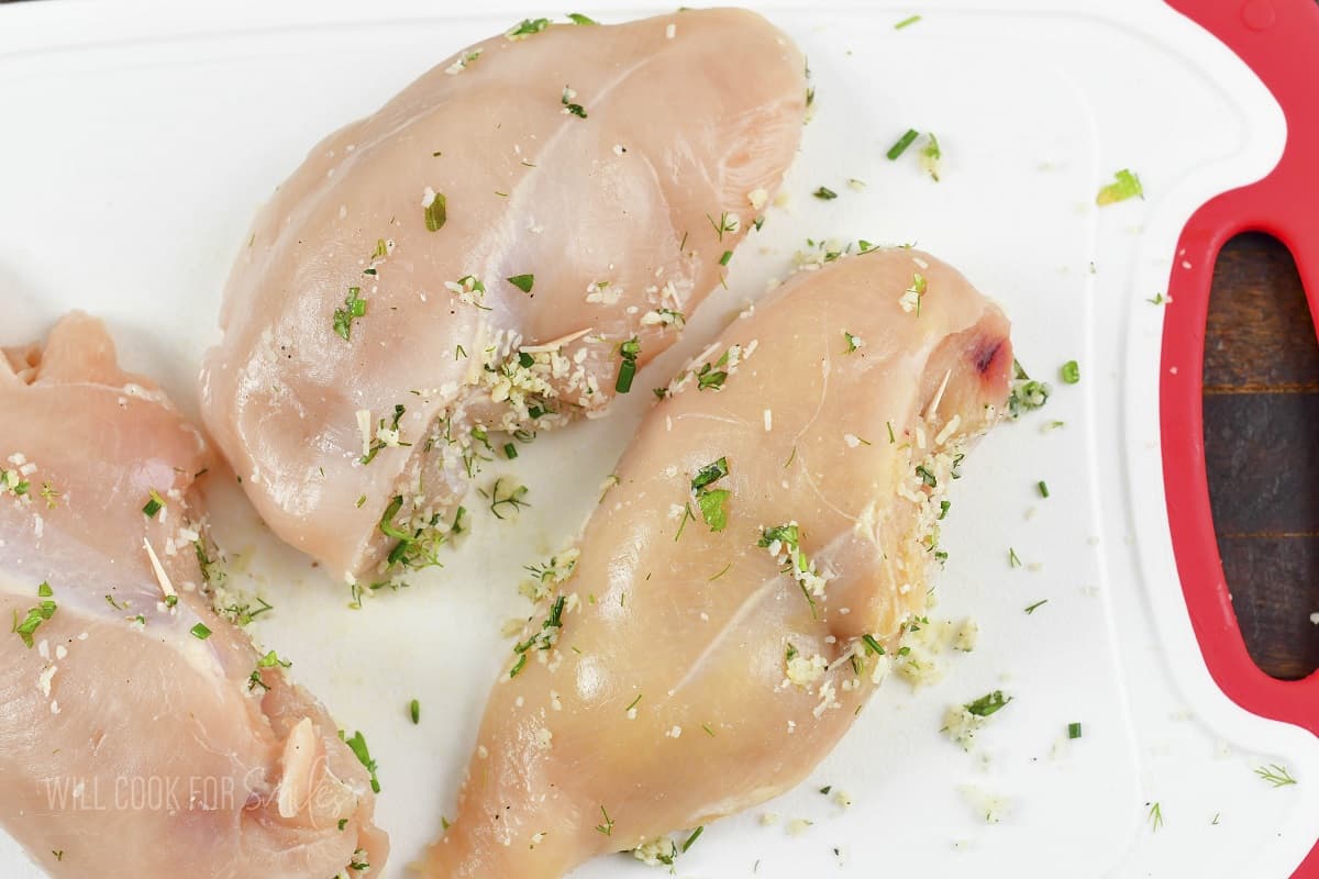 chicken breasts stuffed and the filing a secured with a toothpick.