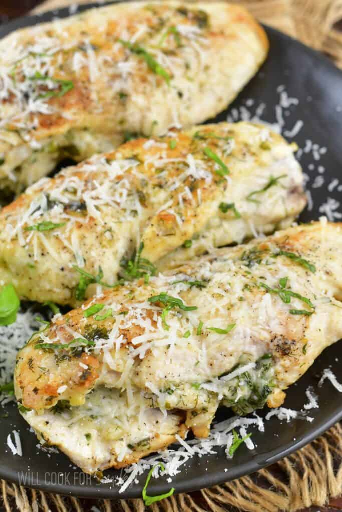 three parmesan and herb chicken breasts on the plate.