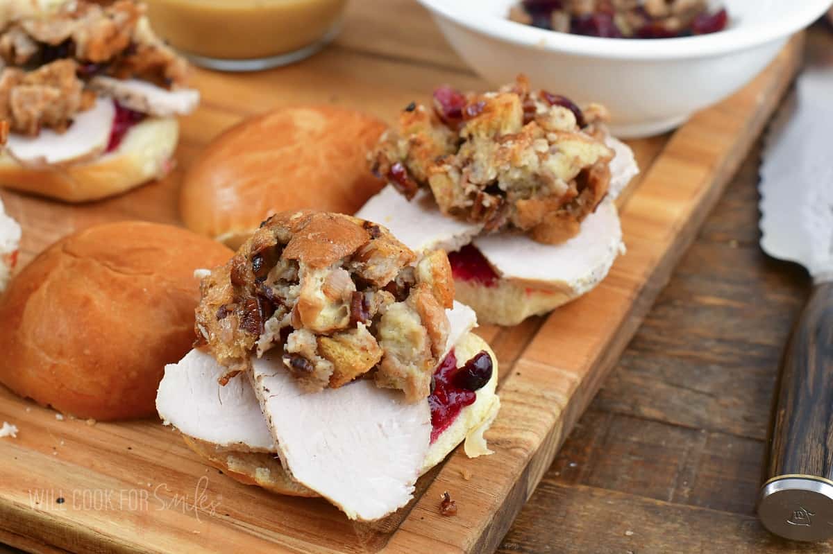 adding scoop of stuffing to the turkey slices.