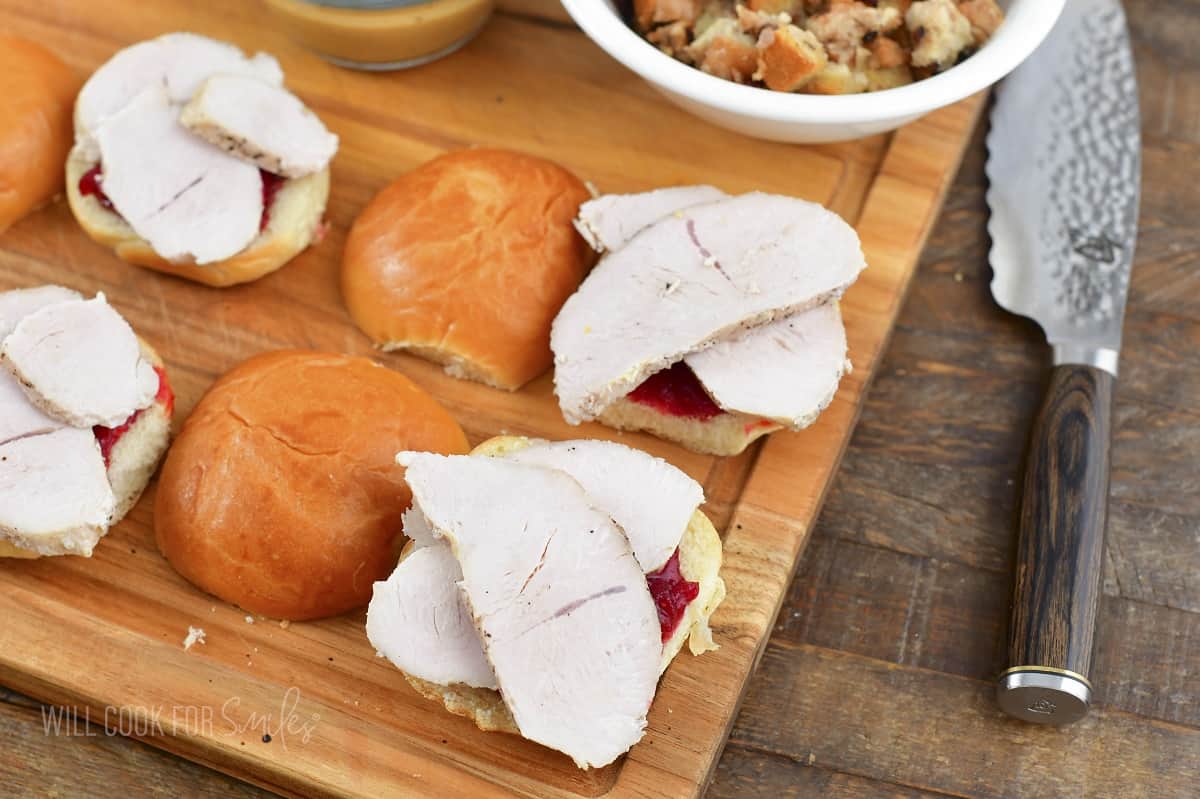 adding turkey slices to the cranberry sauce.