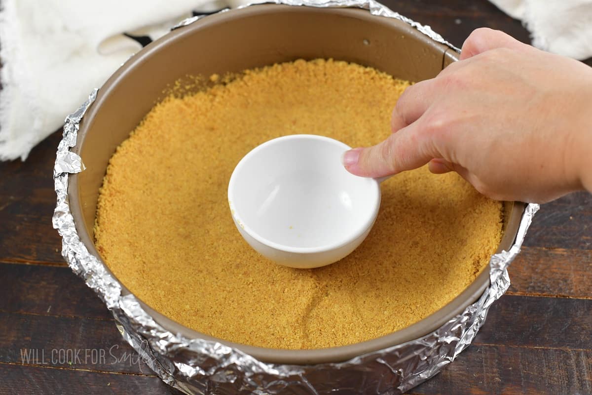 patting the crust down with a measuring cup.
