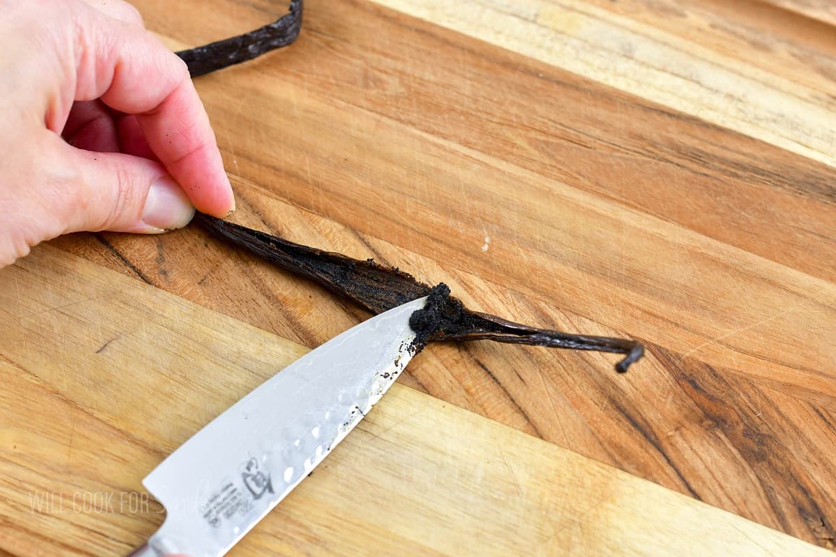scraping the seeds out of the vanilla bean pod.