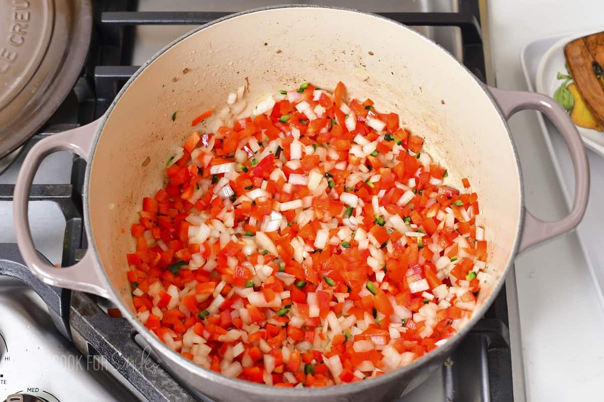 cooking diced veggies in a Dutch oven.