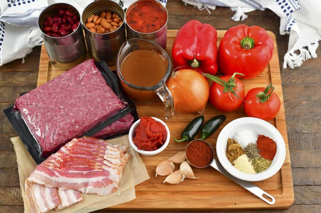 ingredients to make chili recipe in a cutting board.