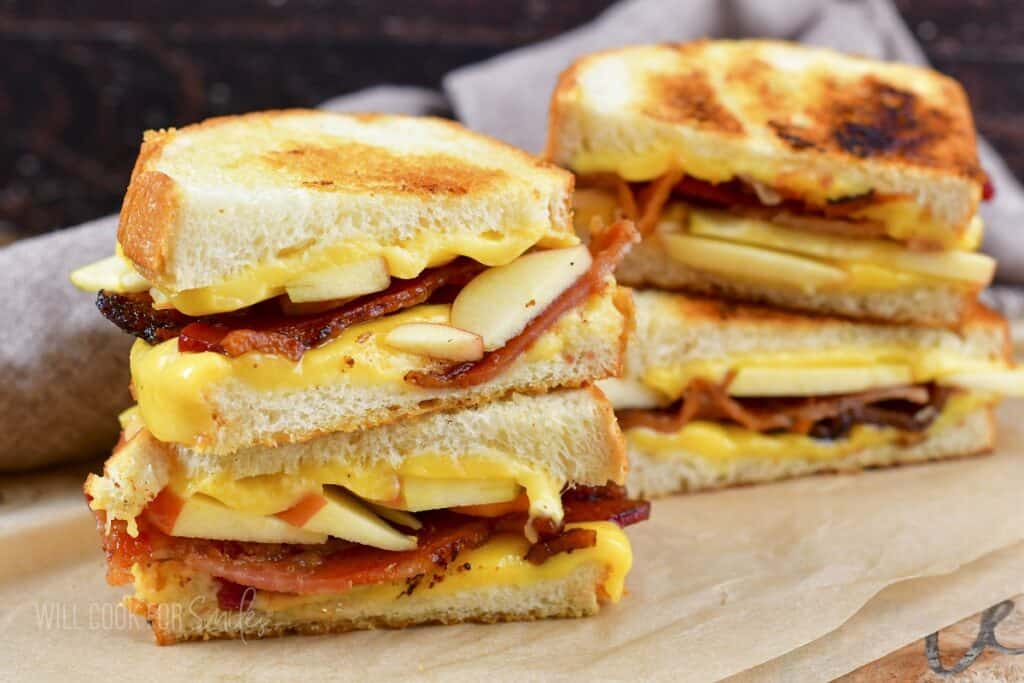 closeup of two stacked bacon and apple grilled cheeses.