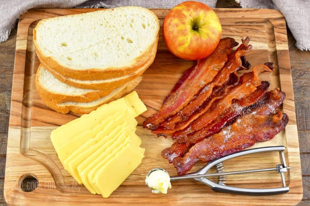ingredients to make bacon apple gouda grilled cheese on the board.