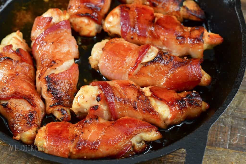 closeup baked bacon wrapped tenders in the skillet.