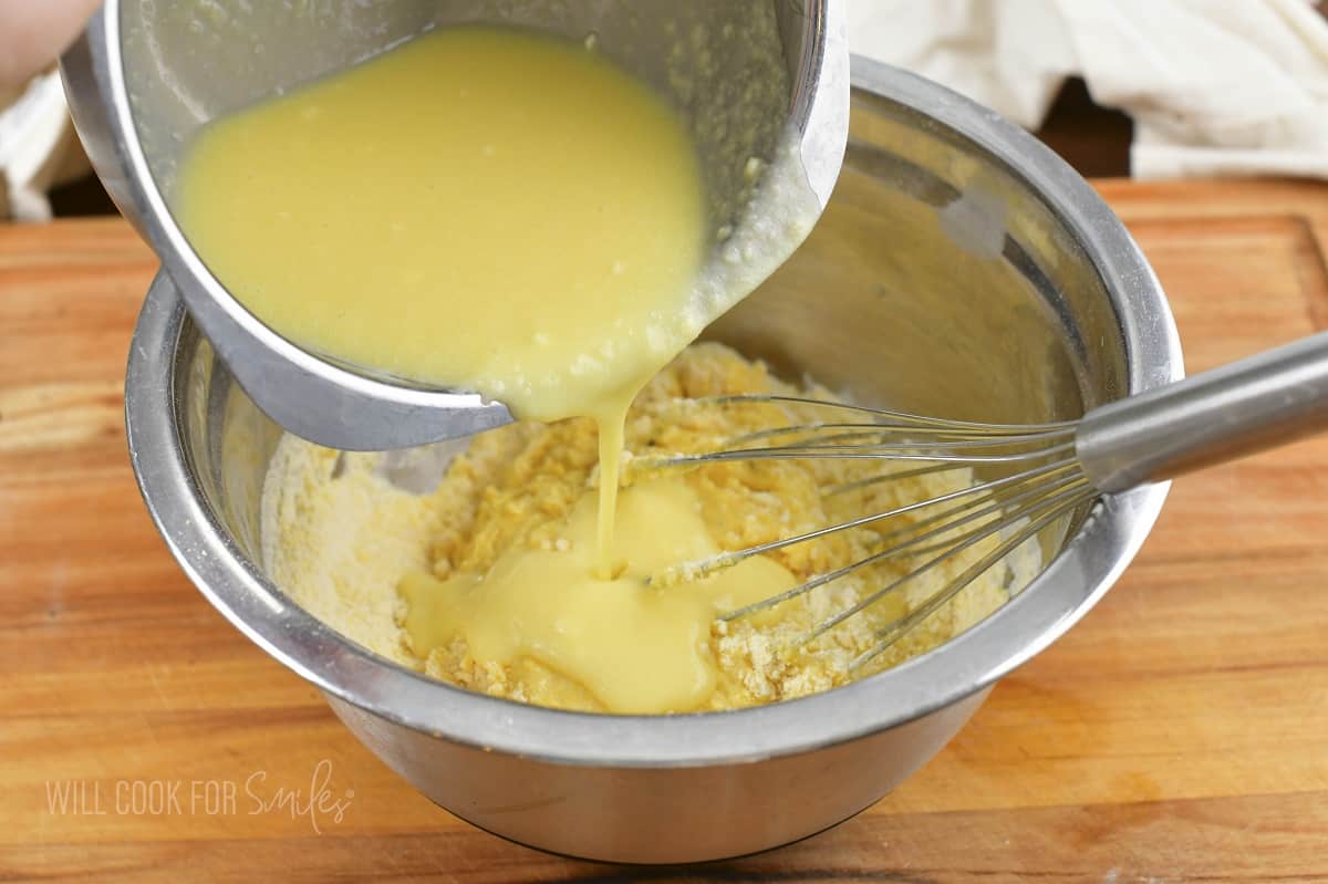 adding wet ingredients into the dry ingredients.