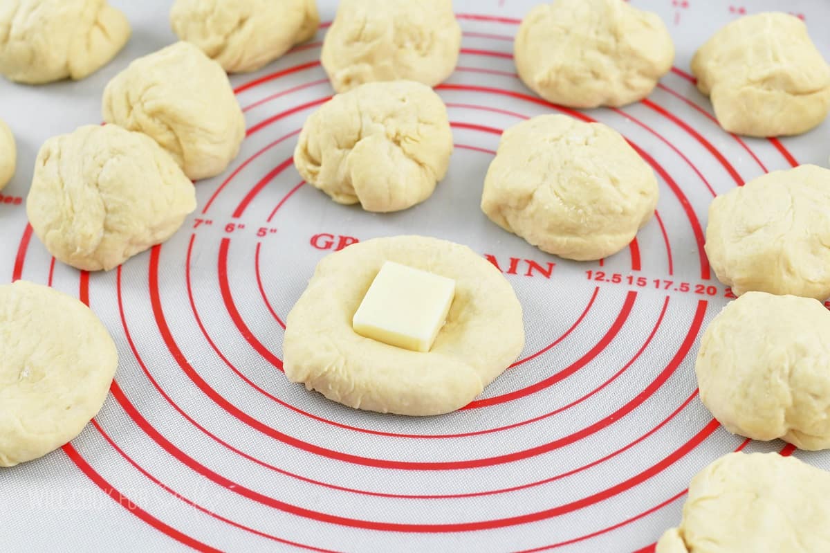 closeup of one piece of dough with a cheese cube in the center.