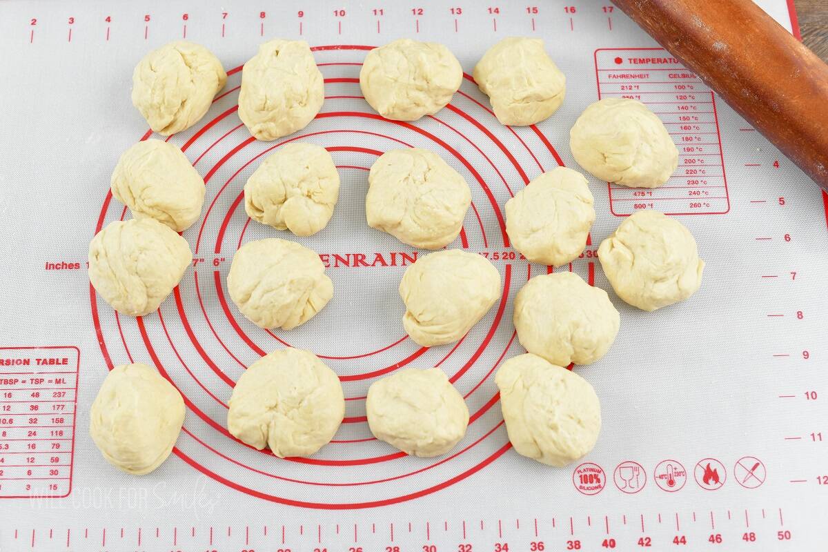 dough separated into eighteen pieces on the silicone mat.