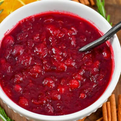 closeup square of cranberry sauce in a white bowl.
