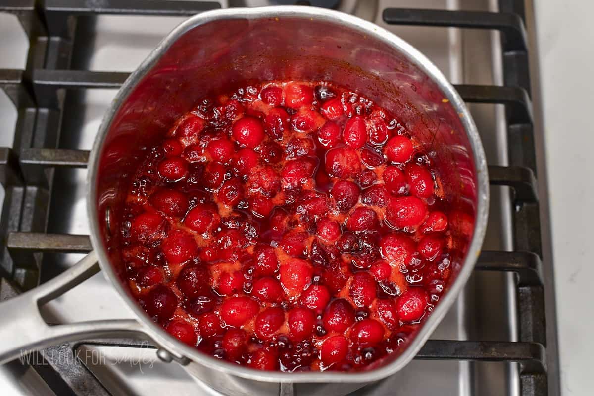 simmering cranberry sauce in a pot.