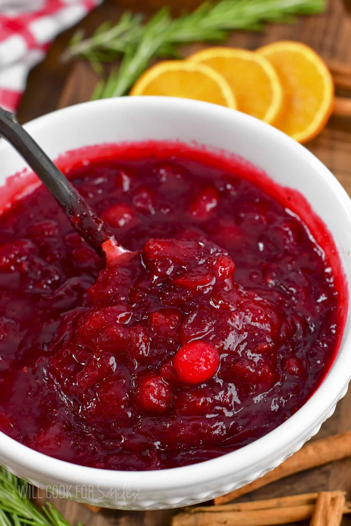 scooping out cranberry sauce from a bowl.