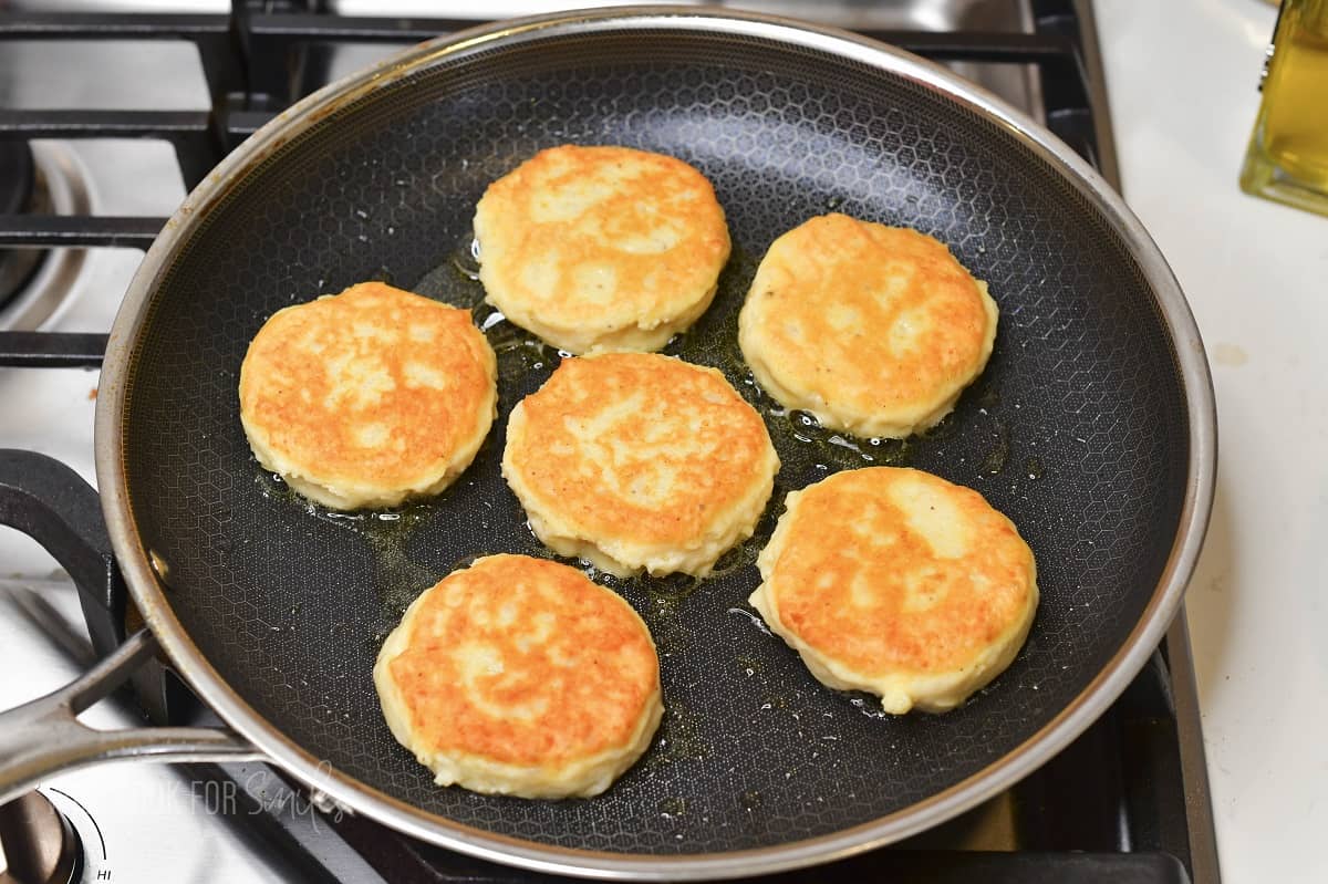 cooked mashed potato cakes in the cooking pan.