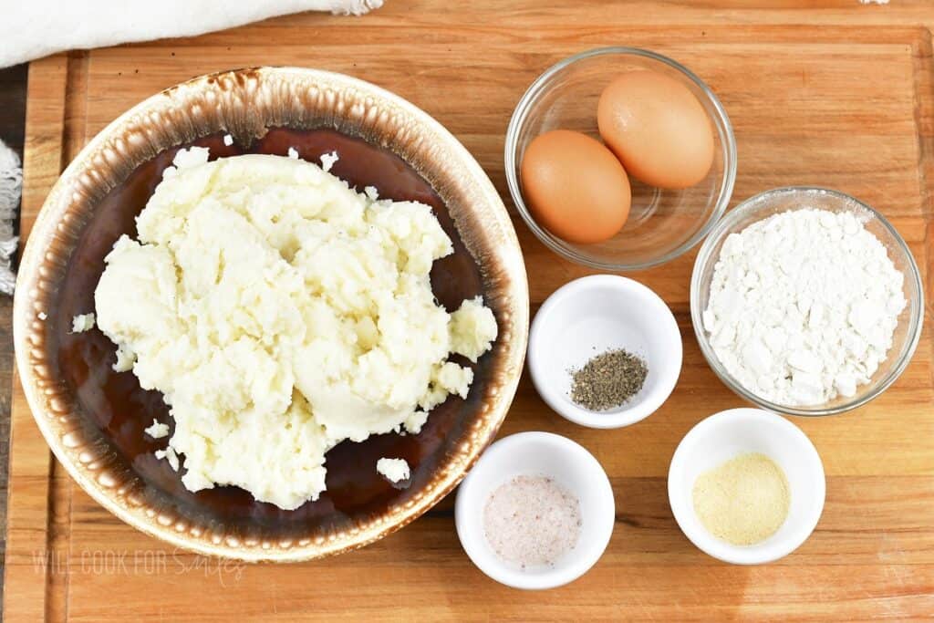 ingredients for mashed potato cakes on the cutting board.