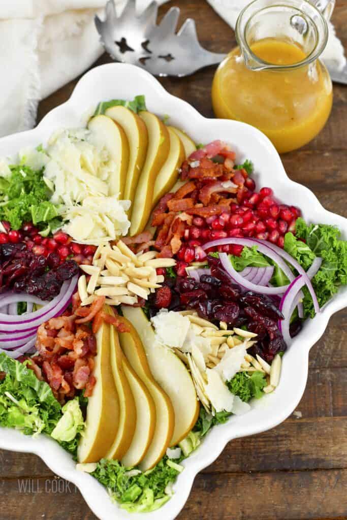 top view of the salad with layered various toppings and dressing.