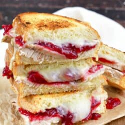 three turkey cranberry grilled cheese halves stacked.