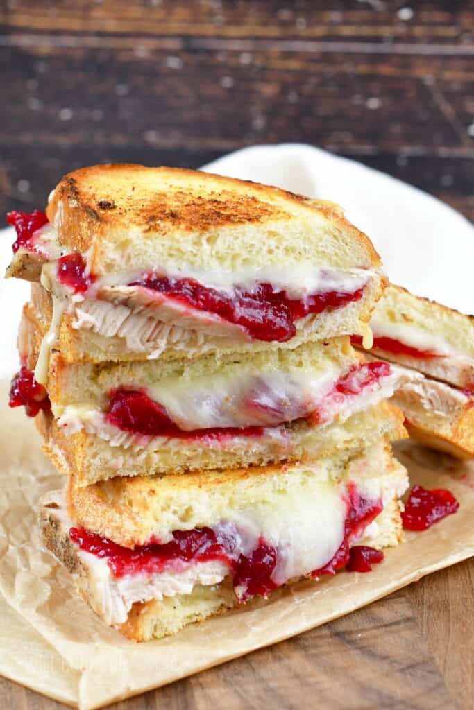 three turkey cranberry grilled cheese halves stacked.