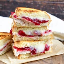 three turkey cranberry grilled cheese halves stacked.