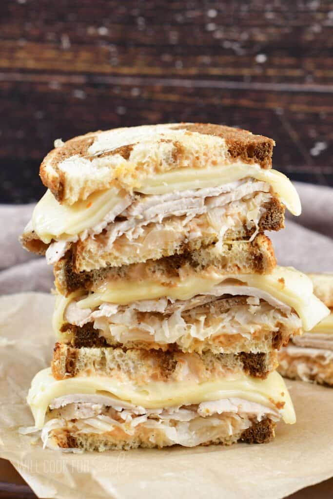 three turkey sandwich halves stacked together.