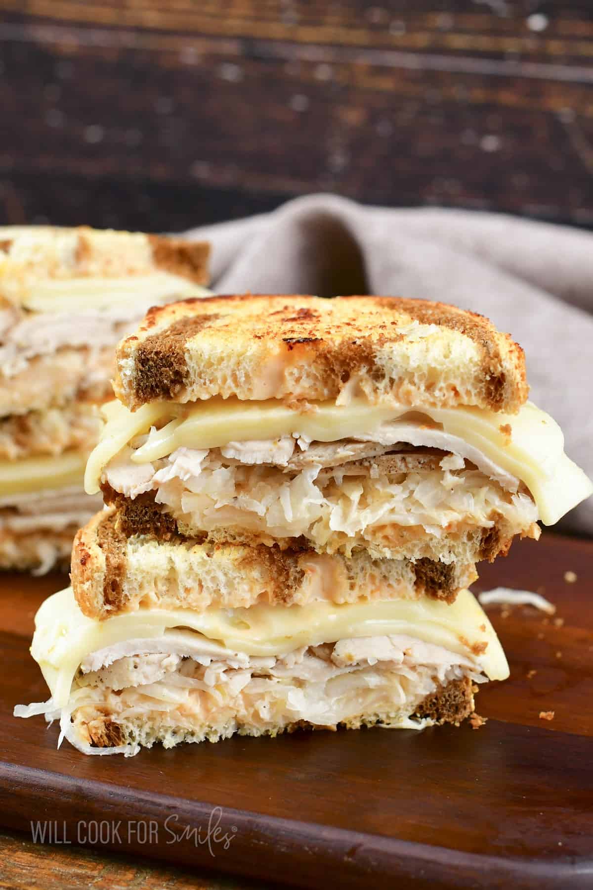 two Turkey Reuben sandwich halves stacked.