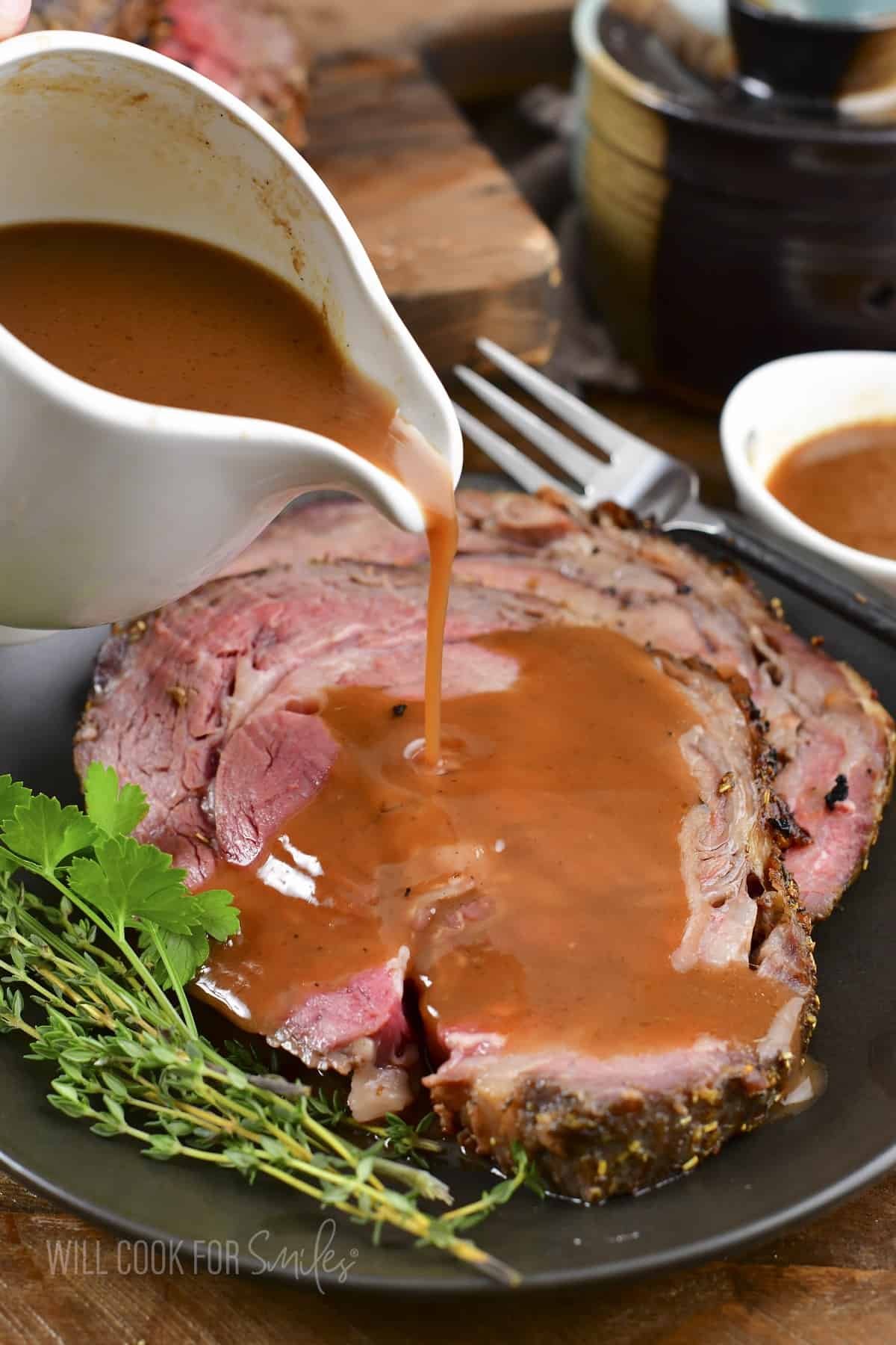 https://www.willcookforsmiles.com/wp-content/uploads/2022/12/Au-Jus-pouring-over-prime-rib.jpg