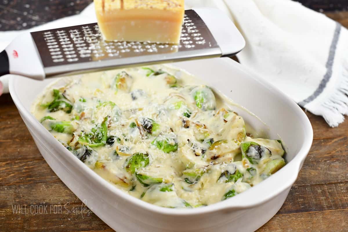 grating parmesan cheese over the brussels in the baking dish.