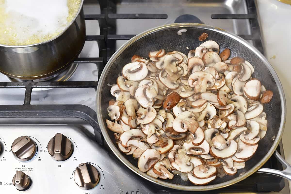 mushrooms cooking in a pan next to orzo cooking in a pot.