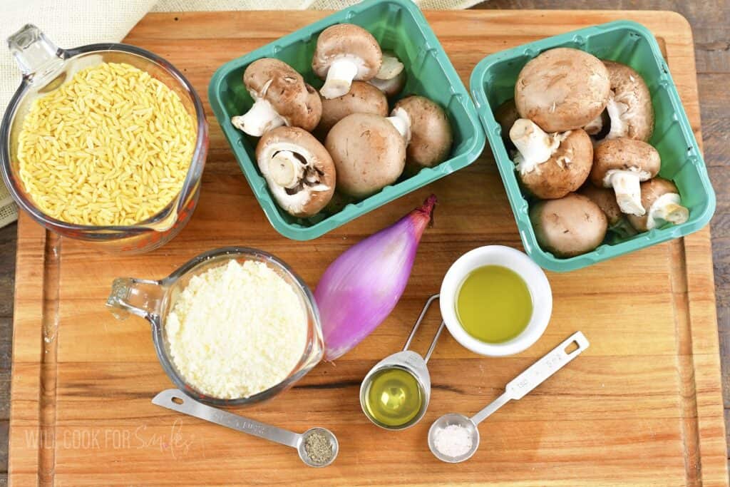 ingredients to make parmesan mushroom orzo on cutting board.