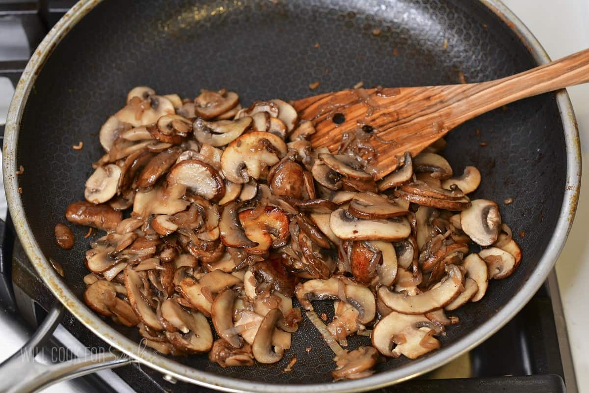 sautéed sliced mushrooms in a cooking pan.