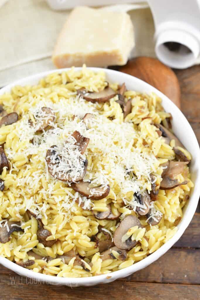 top view of parmesan mushroom orzo in a white bowl.
